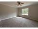 Cozy bedroom featuring a neutral carpet, large window, and ample natural light at 104 Roma Gora Ct, Princeton, NC 27569