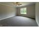 Comfortable bedroom with neutral carpet, ceiling fan and a large window with natural light at 104 Roma Gora Ct, Princeton, NC 27569