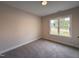 Neutral bedroom featuring plush carpet and natural light from a bright window at 104 Roma Gora Ct, Princeton, NC 27569