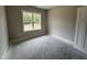 Well-lit, secondary bedroom with a window and neutral color palette at 104 Roma Gora Ct, Princeton, NC 27569