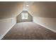 Cozy bonus room with plush carpet and a bright window in the dormer at 104 Roma Gora Ct, Princeton, NC 27569