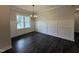 Dining room featuring modern wainscotting, hardwood floors, and a chandelier at 104 Roma Gora Ct, Princeton, NC 27569