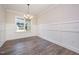 Inviting dining room featuring hardwood floors, bright light, and wainscotting at 104 Roma Gora Ct, Princeton, NC 27569
