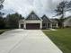 New home featuring a two-car garage, large driveway, and stylish exterior at 104 Roma Gora Ct, Princeton, NC 27569