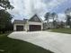 New home featuring a two-car garage, large driveway, and stylish exterior at 104 Roma Gora Ct, Princeton, NC 27569