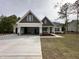 Beautiful two-story home featuring a large driveway, attached garage, and inviting front porch at 104 Roma Gora Ct, Princeton, NC 27569