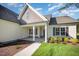 Inviting front entrance featuring columns, a well-kept lawn, and lush landscaping at 104 Roma Gora Ct, Princeton, NC 27569