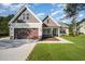 Inviting two-story home showcasing a well-kept lawn, lush landscaping, and an attached two-car garage at 104 Roma Gora Ct, Princeton, NC 27569
