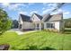 Inviting two-story home showcasing a well-kept lawn, lush landscaping, and an attached garage at 104 Roma Gora Ct, Princeton, NC 27569