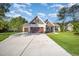 Charming two-story home featuring a spacious driveway, attached two-car garage, and a well-manicured lawn at 104 Roma Gora Ct, Princeton, NC 27569