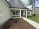 Charming home featuring a covered front porch with stone accents and a landscaped yard at 104 Roma Gora Ct, Princeton, NC 27569