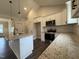 Well-lit kitchen boasts granite counters, stainless appliances, and white cabinets and trim at 104 Roma Gora Ct, Princeton, NC 27569