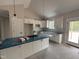Modern kitchen featuring white cabinets and an island with blue countertops at 104 Roma Gora Ct, Princeton, NC 27569