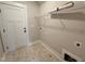 Efficient laundry area with shelving, tile floor, and ample space at 104 Roma Gora Ct, Princeton, NC 27569