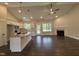 Open-concept living area features hardwood floors, a fireplace, & bright kitchen at 104 Roma Gora Ct, Princeton, NC 27569