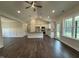 Open-concept living area featuring hardwood floors, a fireplace, and bright kitchen at 104 Roma Gora Ct, Princeton, NC 27569