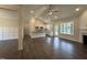 Open-concept living area featuring hardwood floors, a fireplace, and bright kitchen at 104 Roma Gora Ct, Princeton, NC 27569