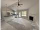 Open-concept living space with a fireplace adjacent to a modern kitchen area at 104 Roma Gora Ct, Princeton, NC 27569
