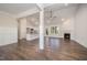 Open-concept living room showcasing hardwood floors, a fireplace, and a modern kitchen at 104 Roma Gora Ct, Princeton, NC 27569