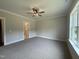 Spacious main bedroom offers neutral carpet, ceiling fan, and a scenic window view at 104 Roma Gora Ct, Princeton, NC 27569