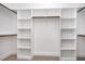 Walk-in closet with custom white built-in shelving at 104 Roma Gora Ct, Princeton, NC 27569