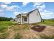 A new house is located on a lush, green lot with a covered porch at 105 Tuskeegee Dr, Smithfield, NC 27577