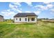 The spacious backyard features lush green grass and a covered patio at 105 Tuskeegee Dr, Smithfield, NC 27577