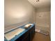 Bathroom featuring a double vanity with a blue countertop, and a shower-tub combo at 105 Tuskeegee Dr, Smithfield, NC 27577