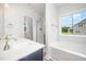 Bright bathroom featuring double sinks, a soaking tub, and a tiled shower behind glass at 105 Tuskeegee Dr, Smithfield, NC 27577