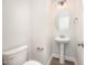 Well-lit half bathroom with an oval mirror and pedestal sink at 105 Tuskeegee Dr, Smithfield, NC 27577