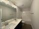 Well-lit bathroom with a double sink vanity and a shower-tub combination at 105 Tuskeegee Dr, Smithfield, NC 27577