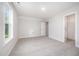 A spacious bedroom with ample natural light and neutral carpeting at 105 Tuskeegee Dr, Smithfield, NC 27577