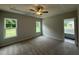 Spacious bedroom featuring a ceiling fan and natural light from the large windows at 105 Tuskeegee Dr, Smithfield, NC 27577