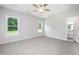 Spacious bedroom with carpet floors, natural light from two windows, and a ceiling fan at 105 Tuskeegee Dr, Smithfield, NC 27577