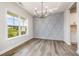Elegant dining room with decorative wall paneling, modern chandelier, and ample natural light at 105 Tuskeegee Dr, Smithfield, NC 27577