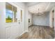 Welcoming entryway leading to a modern dining area with decorative wall paneling and stylish chandelier at 105 Tuskeegee Dr, Smithfield, NC 27577