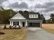 Charming single-story home with white siding, stone accents, and an attached two-car garage at 105 Tuskeegee Dr, Smithfield, NC 27577