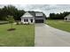Charming single-Gathering home featuring a well-manicured lawn and a two-car garage, complete with a modern black door at 105 Tuskeegee Dr, Smithfield, NC 27577