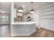 Bright, modern kitchen featuring white cabinets, stainless steel appliances, and pendant lighting at 105 Tuskeegee Dr, Smithfield, NC 27577