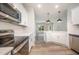 View of the open-concept kitchen with stainless appliances, quartz countertops and wood-look floors at 105 Tuskeegee Dr, Smithfield, NC 27577