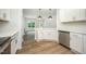 Bright and airy kitchen featuring white cabinetry, stainless steel appliances, and wood-look floors at 105 Tuskeegee Dr, Smithfield, NC 27577