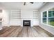 Bright living room featuring a fireplace, built-in shelving, and beautiful flooring at 105 Tuskeegee Dr, Smithfield, NC 27577