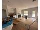 Bright living room featuring built-in shelving, a fireplace, and a view of the backyard at 105 Tuskeegee Dr, Smithfield, NC 27577