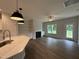 Open concept living room with a cozy fireplace, built-in shelves and an eat-in kitchen island with modern fixtures at 105 Tuskeegee Dr, Smithfield, NC 27577