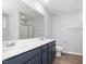 A bathroom features double sinks, quartz countertops, a glass enclosed shower, and modern fixtures at 106 Burnello Ct, Princeton, NC 27569