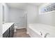 A full bathroom features a soaking tub, a glass enclosed shower, and modern fixtures at 106 Burnello Ct, Princeton, NC 27569