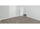 A well-lit bedroom, features two doors and a neutral color scheme at 106 Burnello Ct, Princeton, NC 27569