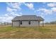 Exterior of house displays gray siding, dark roof and level backyard at 106 Burnello Ct, Princeton, NC 27569