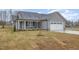 Charming single story home with gray siding, stone accents, and a two car garage at 106 Burnello Ct, Princeton, NC 27569