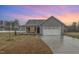 Beautiful single story home with gray siding, stone accents and lovely sunset sky at 106 Burnello Ct, Princeton, NC 27569